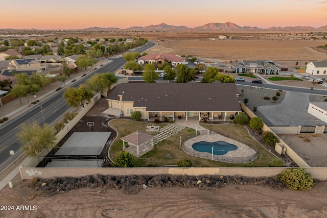 1409 E Dove Pl, Casa Grande, AZ 85122 - aerial view at dusk of view of pool, a mountain view, and a residential view