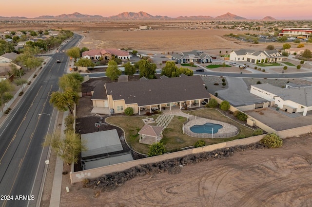 1409 E Dove Pl, Casa Grande, AZ 85122 - aerial view of property's location featuring a mountain backdrop, nearby suburban area, and a pool