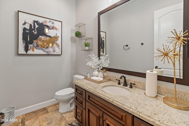 1409 E Dove Pl, Casa Grande, AZ 85122 - bathroom with vanity, baseboards, toilet, and stone finish floors