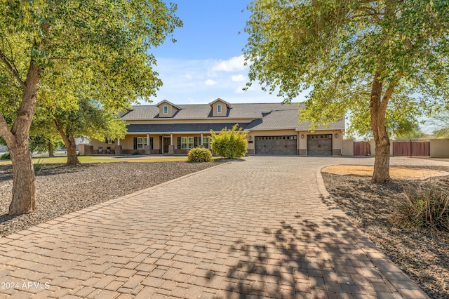 1409 E Dove Pl, Casa Grande, AZ 85122 - view of front of house with an attached garage, decorative driveway, a porch, and stucco siding