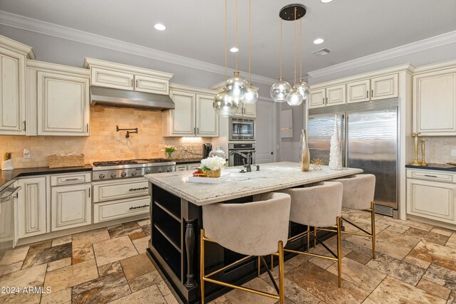 1409 E Dove Pl, Casa Grande, AZ 85122 - kitchen with cream cabinetry, built in appliances, ornamental molding, and recessed lighting
