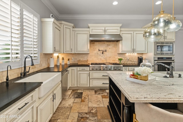 1409 E Dove Pl, Casa Grande, AZ 85122 - kitchen with cream cabinetry, appliances with stainless steel finishes, a sink, stone tile flooring, and ornamental molding