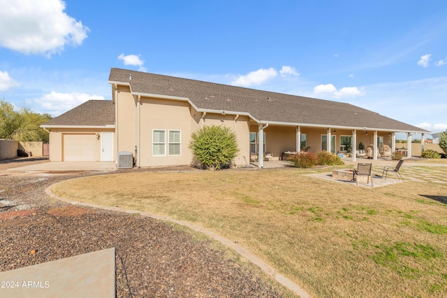 1409 E Dove Pl, Casa Grande, AZ 85122 - rear view of house with an attached garage, central AC, driveway, and stucco siding