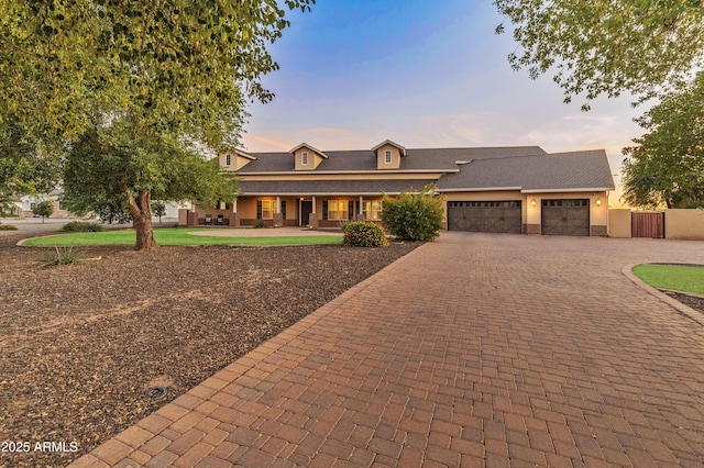 1409 E Dove Pl, Casa Grande, AZ 85122 - view of front of property with a garage, decorative driveway, covered porch, and stucco siding