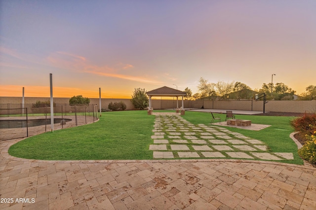 1409 E Dove Pl, Casa Grande, AZ 85122 - yard at dusk featuring a gazebo, a patio, and an outdoor fire pit