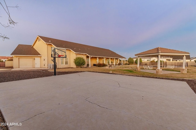 1409 E Dove Pl, Casa Grande, AZ 85122 - view of front facade featuring a gazebo, concrete driveway, a garage, and stucco siding