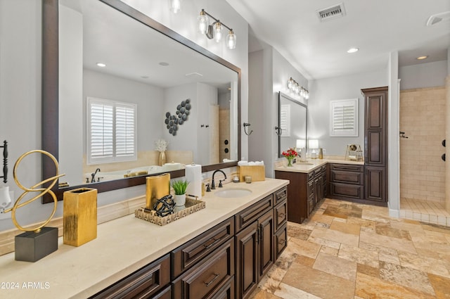 1409 E Dove Pl, Casa Grande, AZ 85122 - full bathroom with two vanities, tiled shower, stone tile flooring, a tub, and recessed lighting