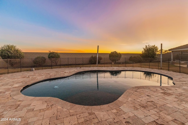 1409 E Dove Pl, Casa Grande, AZ 85122 - pool at dusk with a fenced backyard and a patio
