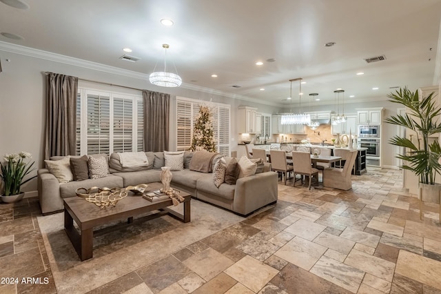 1409 E Dove Pl, Casa Grande, AZ 85122 - living room with a chandelier, recessed lighting, stone tile flooring, and crown molding