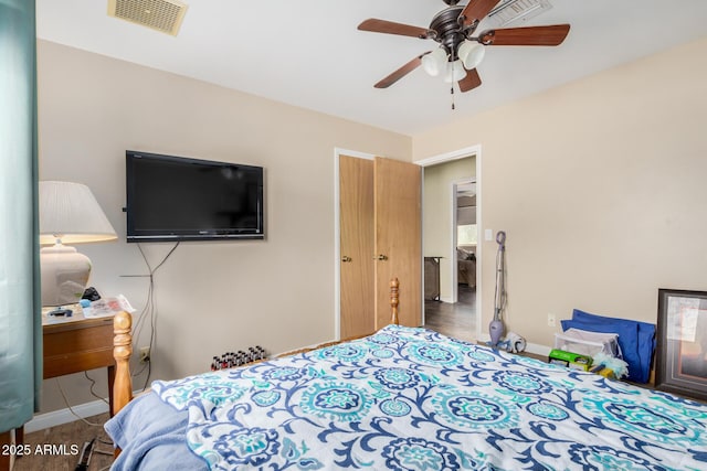 bedroom with a ceiling fan, baseboards, and visible vents