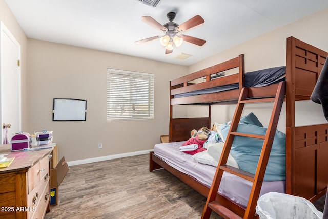 bedroom featuring a ceiling fan, wood finished floors, and baseboards