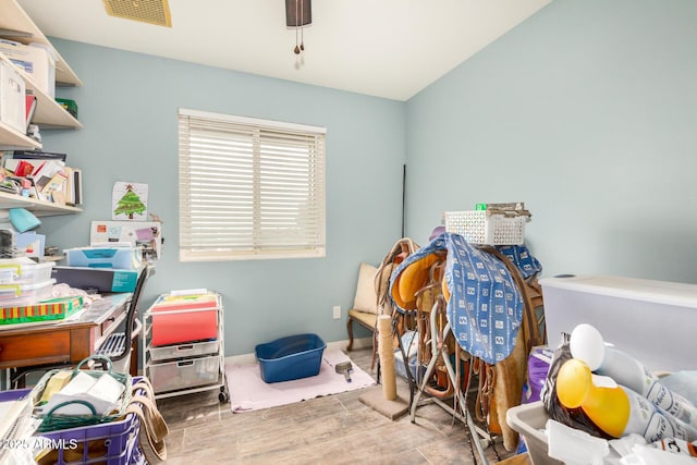 interior space with visible vents, baseboards, and wood finished floors