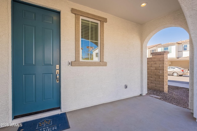 property entrance featuring stucco siding