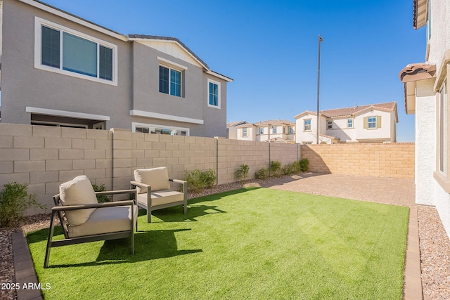 view of yard featuring a residential view, a patio, and a fenced backyard