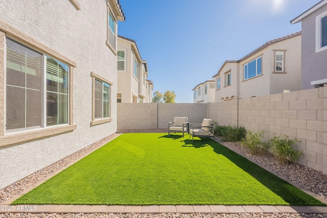 view of yard with a residential view and a fenced backyard