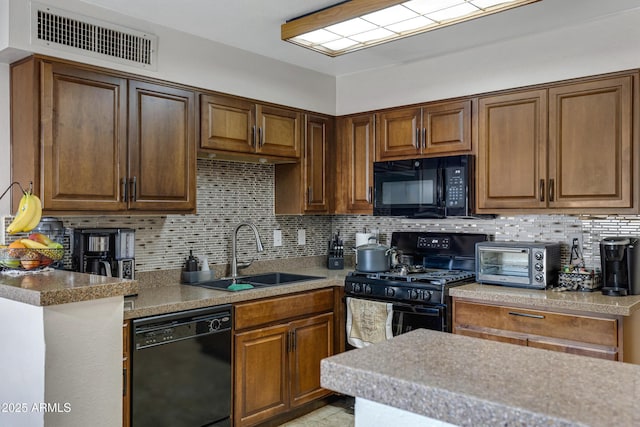 kitchen featuring sink, backsplash, and black appliances