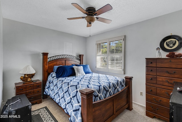 bedroom with light carpet, a textured ceiling, and ceiling fan