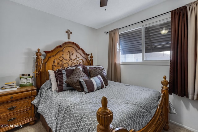 carpeted bedroom with ceiling fan and a textured ceiling