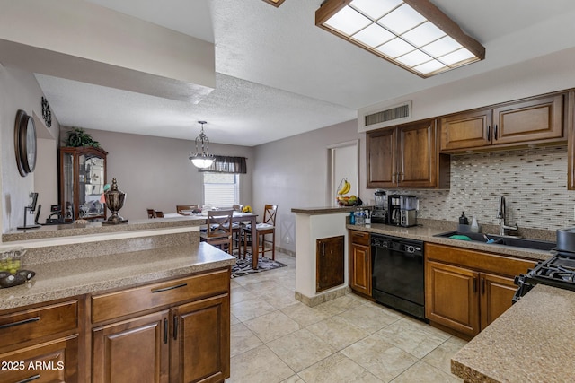 kitchen with decorative light fixtures, sink, light tile patterned floors, black appliances, and decorative backsplash