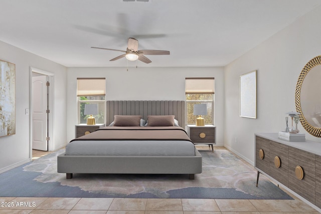 bedroom featuring baseboards, a ceiling fan, and tile patterned floors