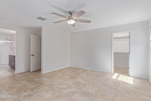 unfurnished room with baseboards, light tile patterned flooring, visible vents, and a ceiling fan