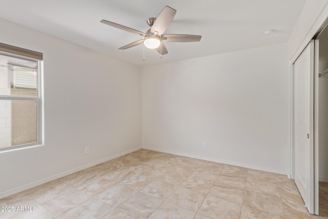 unfurnished bedroom with a ceiling fan, baseboards, and a closet