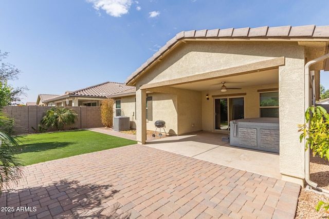 back of property with ceiling fan, a patio, fence, and stucco siding