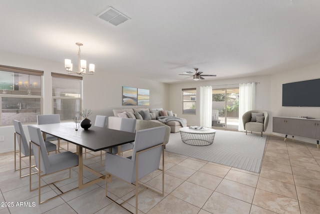 dining room featuring light tile patterned floors, visible vents, and ceiling fan with notable chandelier