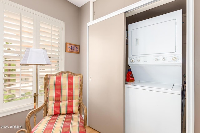 laundry room with stacked washer / dryer and laundry area