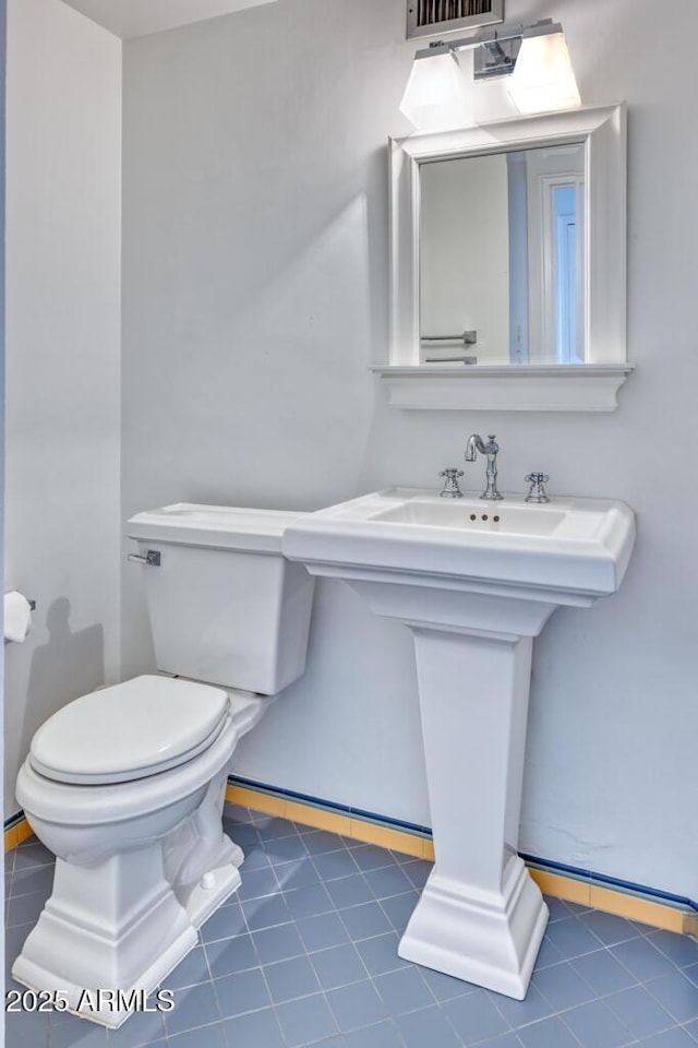 2201 N Central Ave Unit 3D, Phoenix, AZ 85004 - bathroom featuring toilet, baseboards, tile patterned flooring, and a sink