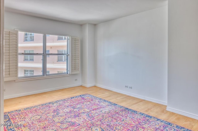 2201 N Central Ave Unit 3D, Phoenix, AZ 85004 - unfurnished room featuring wood finished floors and baseboards