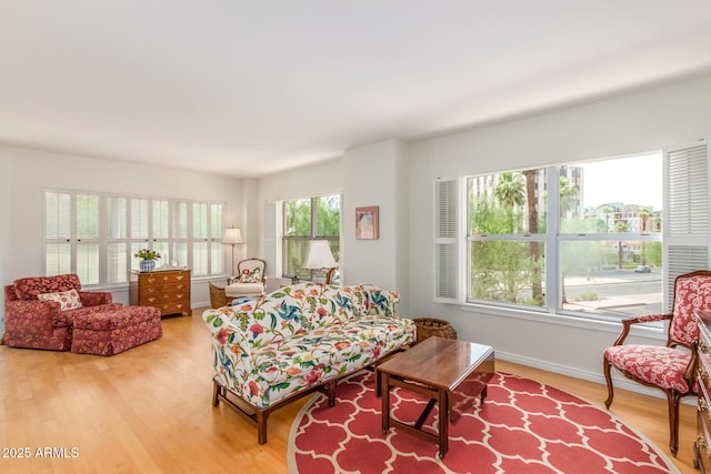 living room featuring baseboards and light wood-style flooring