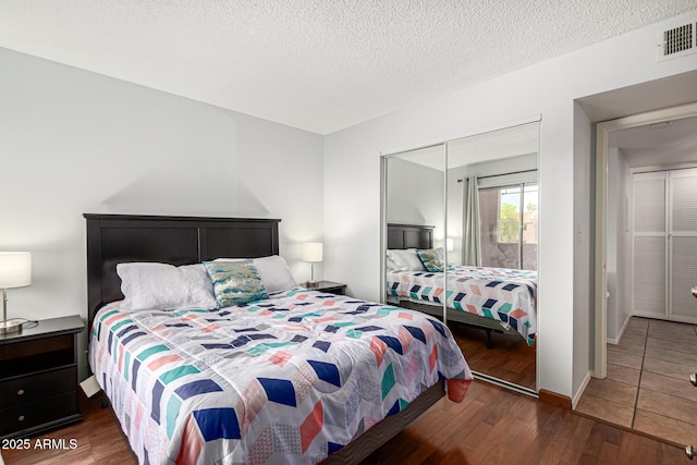 540 N May Unit 3117, Mesa, AZ 85201 - bedroom with wood finished floors and a textured ceiling