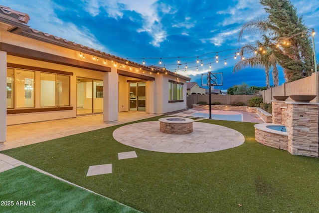 yard at dusk with a patio and an outdoor fire pit