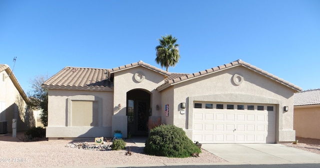 view of front of home featuring cooling unit and a garage