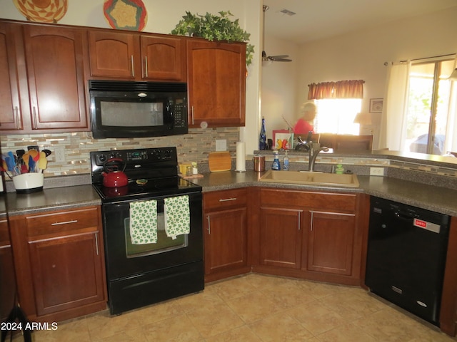 kitchen featuring light tile patterned flooring, sink, decorative backsplash, and black appliances