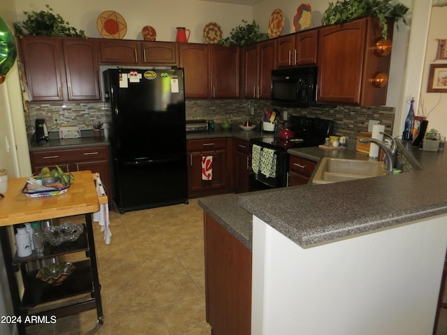 kitchen with backsplash, kitchen peninsula, sink, and black appliances