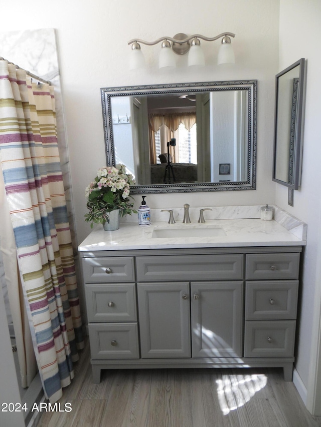 bathroom with vanity, wood-type flooring, and walk in shower