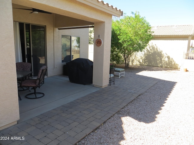 view of patio featuring area for grilling and ceiling fan