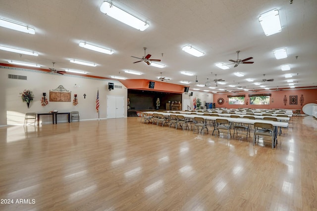 misc room with ceiling fan and light hardwood / wood-style floors