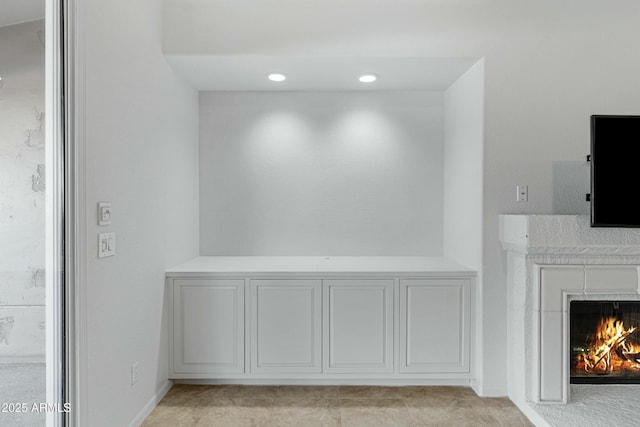 interior details with recessed lighting and a lit fireplace