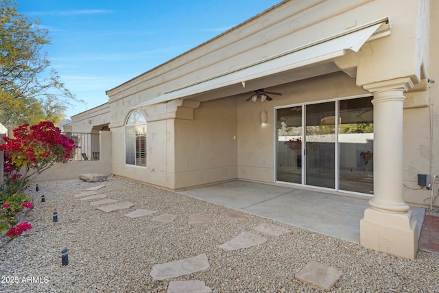 rear view of property featuring a patio, fence, a ceiling fan, and stucco siding