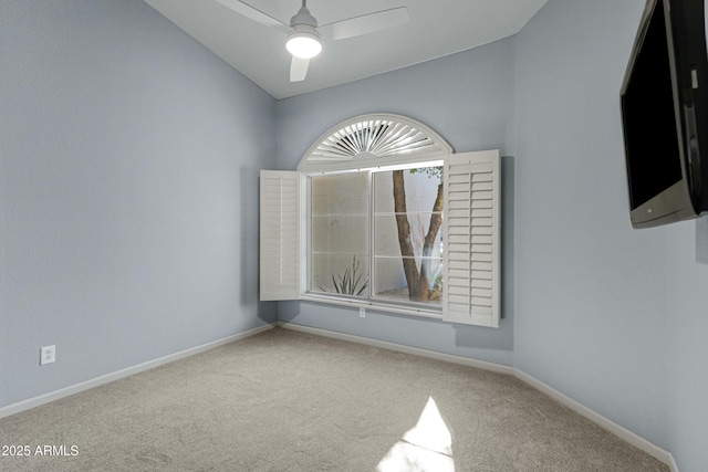 spare room featuring carpet, ceiling fan, and baseboards