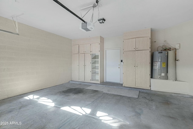 garage with water heater, concrete block wall, and a garage door opener