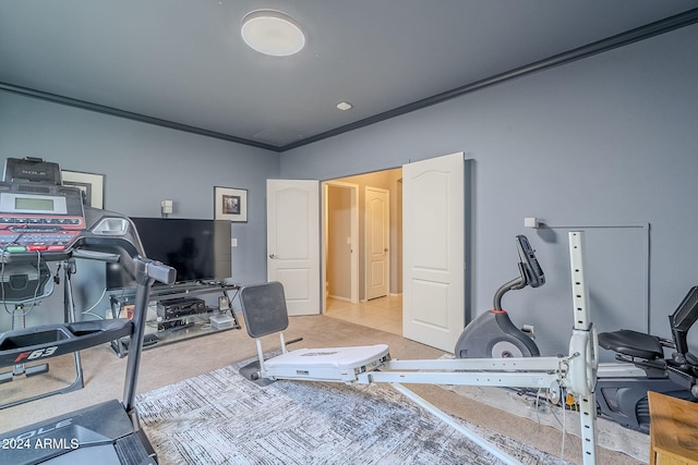 workout room featuring light tile patterned floors and crown molding