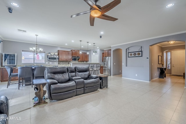 living room featuring ceiling fan with notable chandelier and ornamental molding