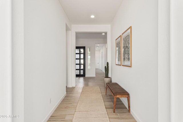 hall with light hardwood / wood-style flooring