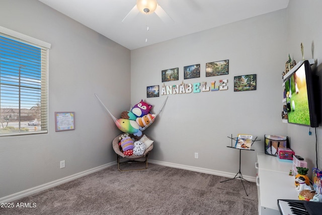 recreation room with carpet and baseboards