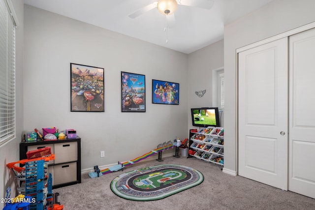 rec room featuring carpet, a ceiling fan, and baseboards