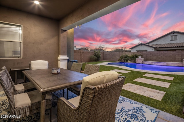 view of patio with a fenced backyard, a fenced in pool, and outdoor dining space